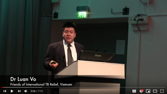 Vietnamese man speaking at a lectern