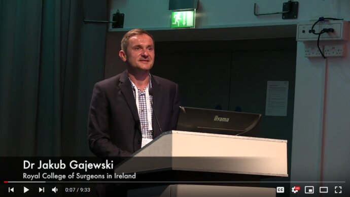 European man speaking at a lectern