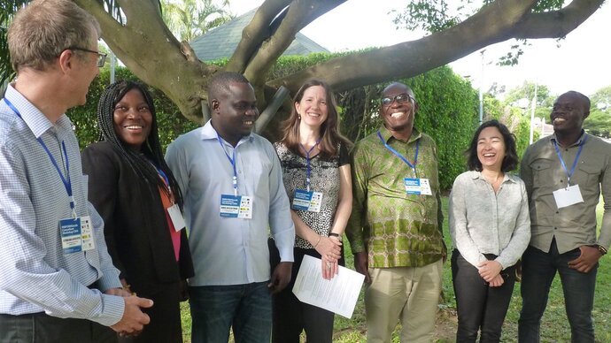 The Ghana and Swiss teams A standing row of smiling men and women