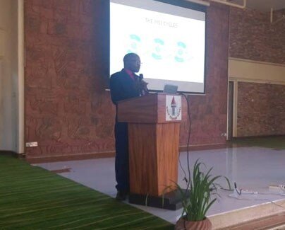 Dr. Xavier Nsabagasani, PERFORM2Scale Coordinator in Uganda, making a presentation on the country’s progress (MSI and NSSG)