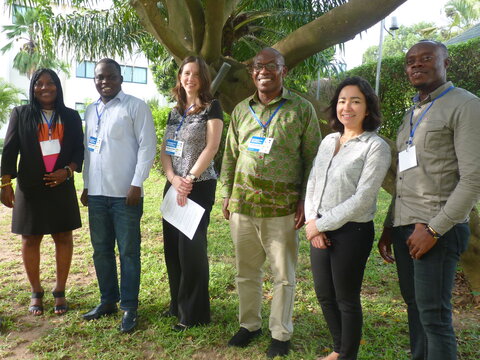 A smiling group of African and European men and women