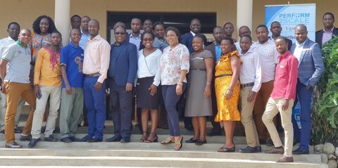 District staff from Ntoroko, Bunyangabu and Kabarole meet in Uganda A group of smiling African men and women standing on steps and looking at the camera